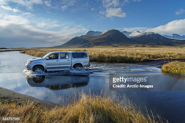 truck crossing a river, iceland - incidental people stock pictures, royalty-free photos & images