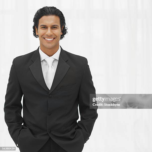 portrait of a groom standing with his hands in his pockets - pocket square fotografías e imágenes de stock