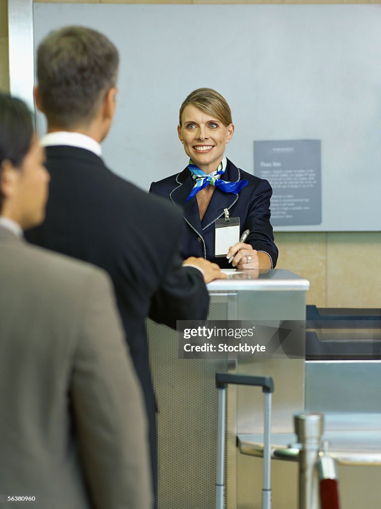 Business executives checking in luggage at an airline ticket counter