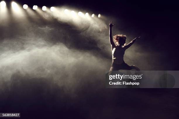 portrait of woman jumping - performer bildbanksfoton och bilder