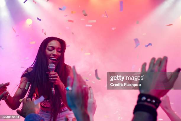 band performing on stage at music concert - pink confetti stock pictures, royalty-free photos & images