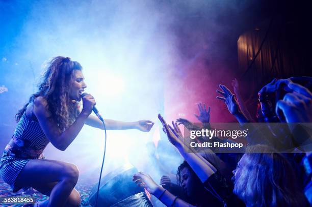 singer performing on stage reaching out to crowd - blues musician stock pictures, royalty-free photos & images