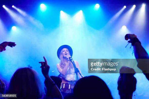 band performing on stage at music concert - blonde female singers stock-fotos und bilder
