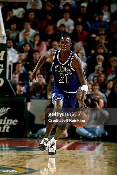 Kevin Garnett of the Minnesota Timberwolves dribbles upcourt against the Seattle Sonics during an NBA game on February 14, 1996 at Key Arena in...