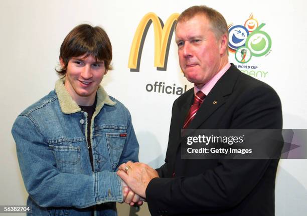 World Cup winner Sir Geoff Hurst of England shakes hands with Lionel Messi of Argentina and Barcelona during a FIFA Press conference prior to...