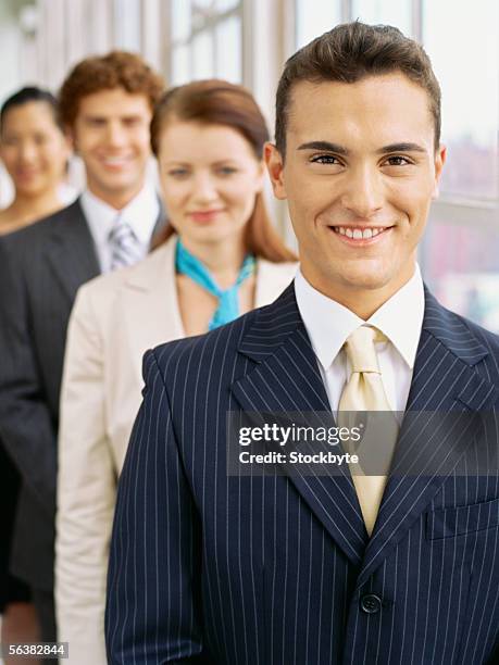 portrait of two businessmen and two businesswomen smiling - striped suit stock pictures, royalty-free photos & images