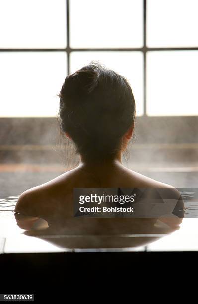 woman bathing at hot spring resort - japanese women bath stock pictures, royalty-free photos & images