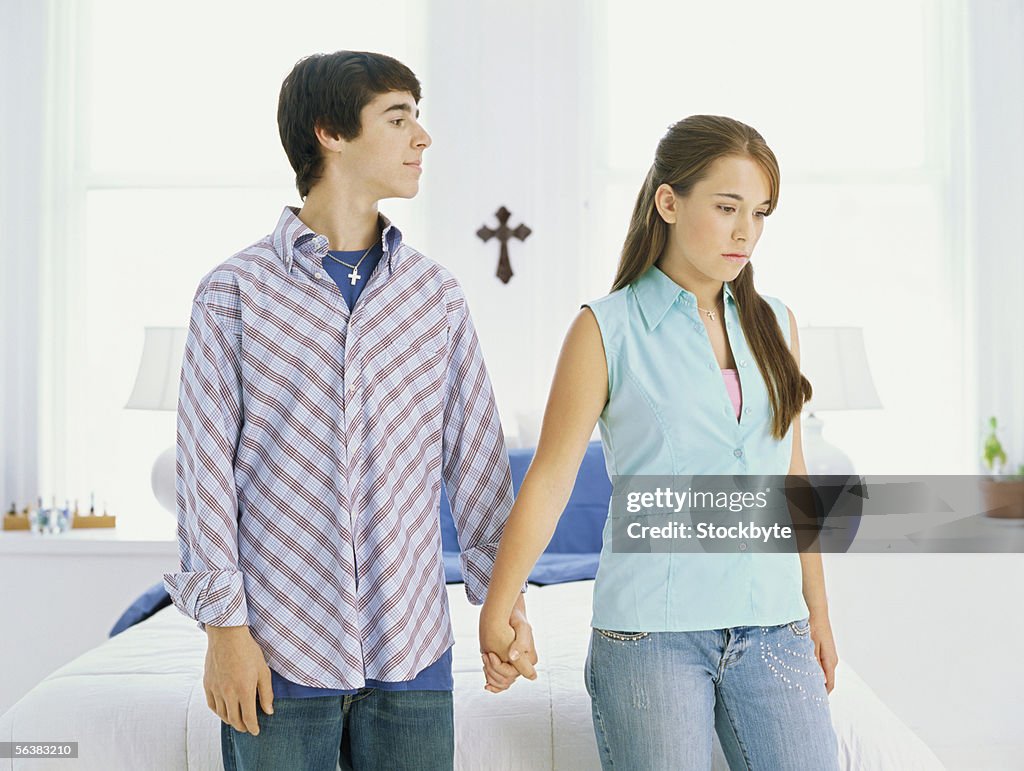 Teenage couple holding hands