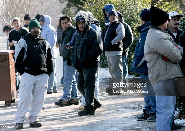 Day laborers wait for employers in a program run by the Eden Korean Presbyterian Church near an informal day labor pick-up site December 8, 2005 in...