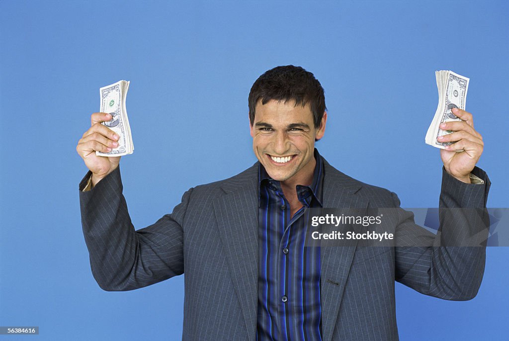 Portrait of a businessman holding money