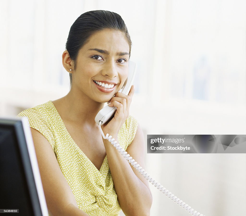 Portrait of a businesswoman talking on the telephone in an office