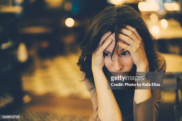 worried woman - krise stock-fotos und bilder