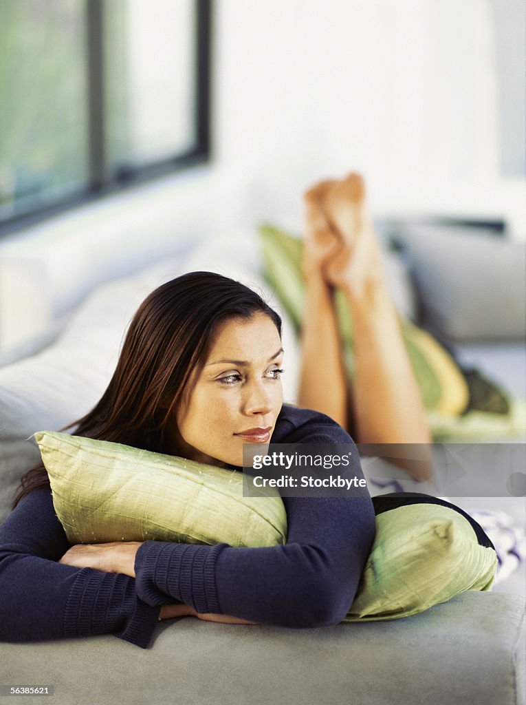 Young woman lying on a couch