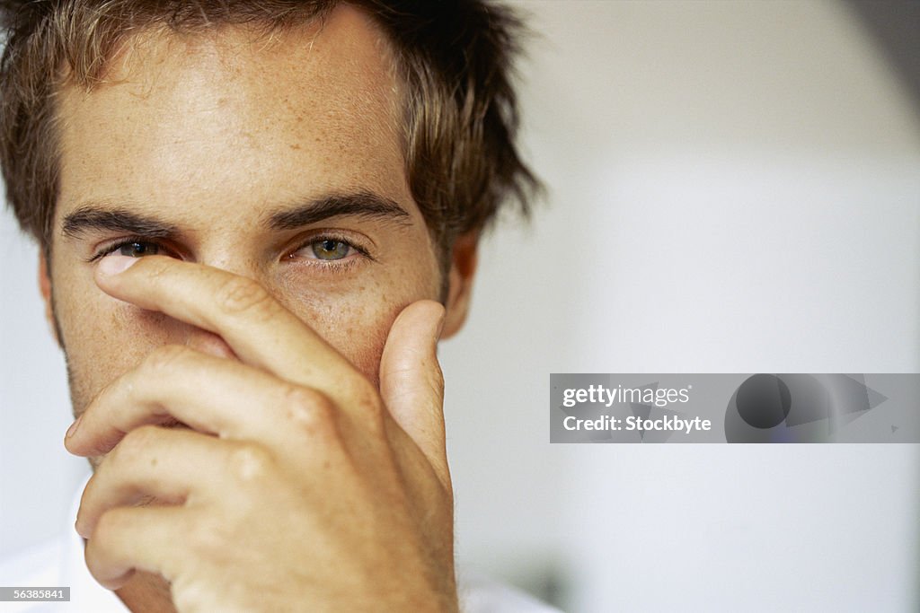 Portrait of a businessman covering his mouth with his hand