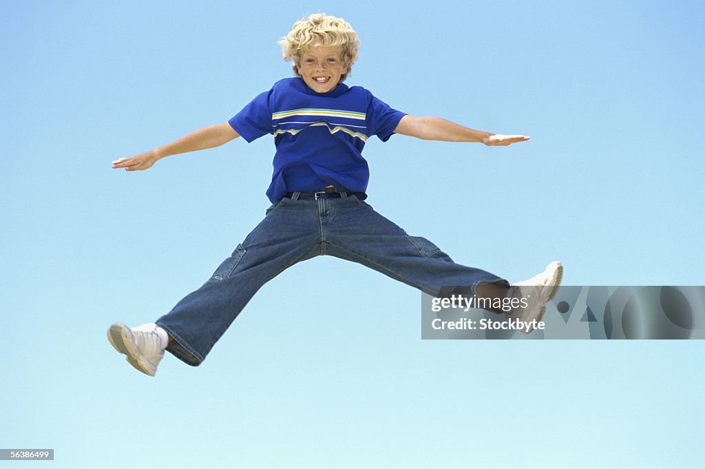 Portrait of a boy jumping in mid-air