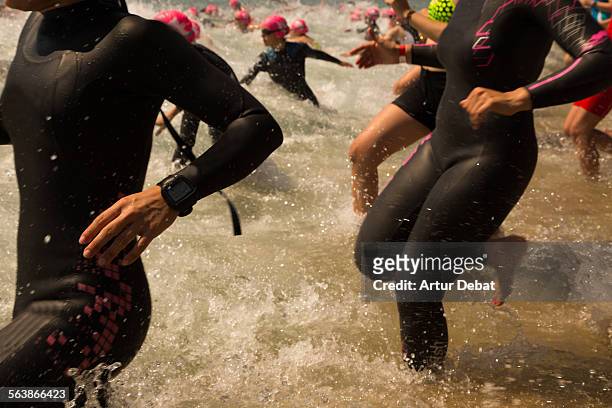 triathlon athletes on the start - neoprene fotografías e imágenes de stock