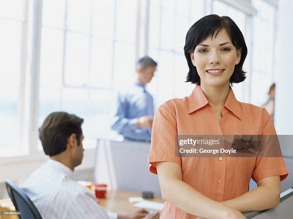 Portrait of a businesswoman standing in an office cubicle