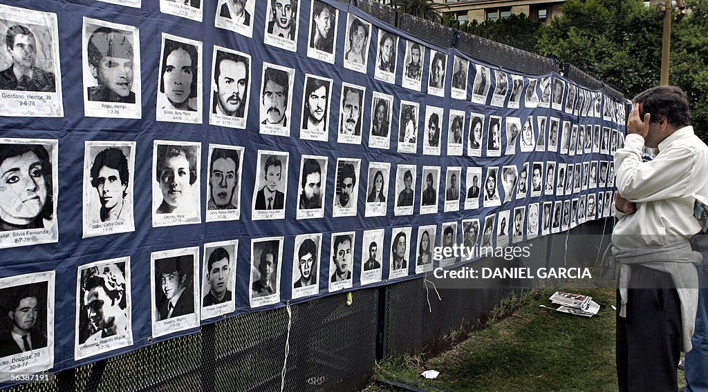 An man looks at pictures of missing peop