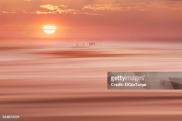 people fishing early in the morning at beach - canelones ストックフォトと画像
