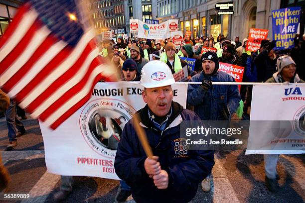 Martin Downey, the president of a local union, waves an American flag as he marches with other AFL-CIO members December 8, 2005 in Boston,...