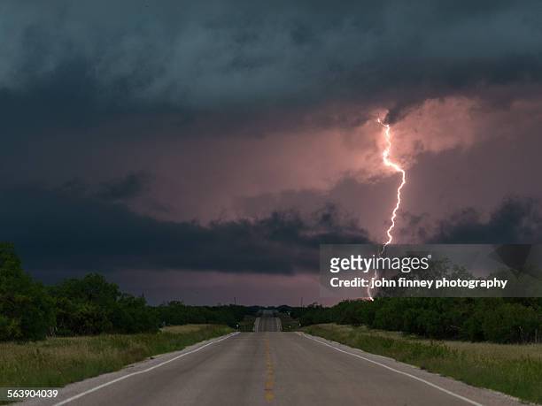 lightning over a texas highway - san angelo texas stock-fotos und bilder