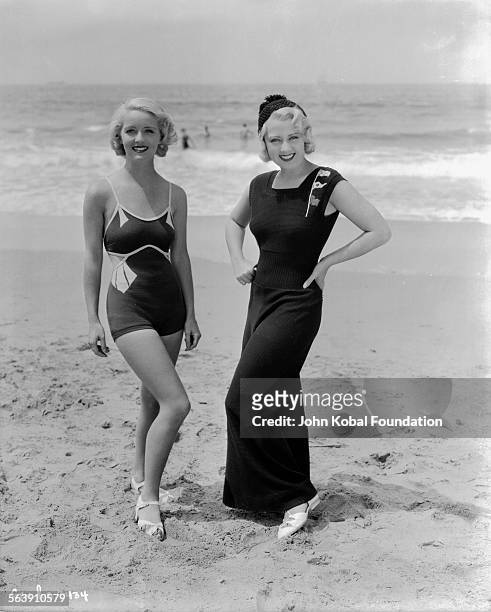 Portrait of actresses Bette Davis and Joan Blondell on a beach, as they appear in the film 'Three on a Match', for Warner Bros Studios, 1932.