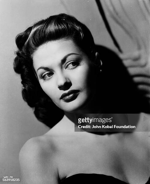 Headshot of actress Yvonne De Carlo wearing an off the shoulder dress, for Universal Pictures, 1945.