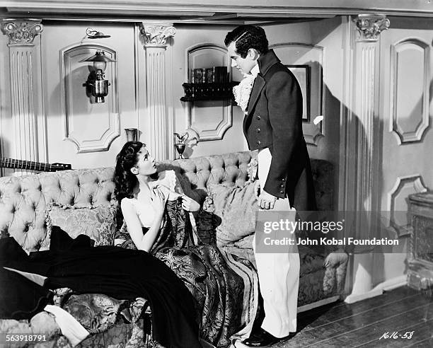 Actress Yvonne De Carlo in a state of undress with another actor in a scene from the film 'Buccaneer's Girl', for Universal Pictures, 1950.