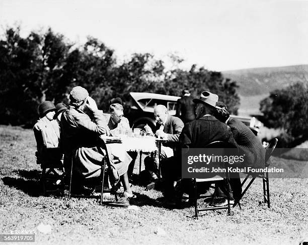 Filmmaker Cecil B DeMille setting up an outdoor dinner scene on the set of the film 'The Squaw Man', for MGM Studios, February 11th 1931.