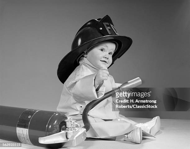 1960s BABY FIREMAN WITH SAFETY HAT COAT AND FIRE EXTINGUISHER