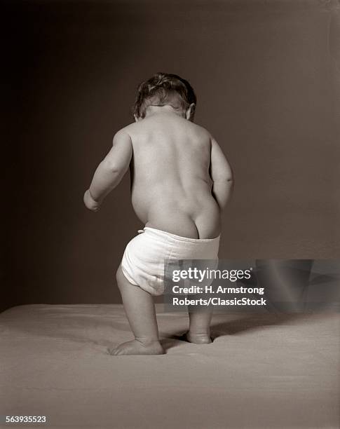 1960s BABY STANDING WITH DIAPER FALLING DOWN NUDE HUMOROUS