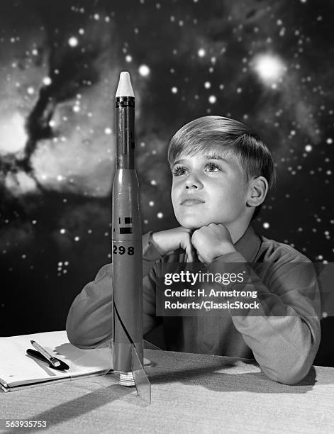 1960s BOY WITH MODEL ROCKET AND OUTER SPACE BACKGROUND