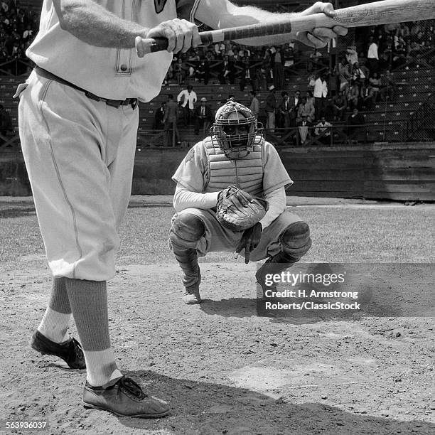 1950s BASEBALL PLAYER ABOUT TO BUNT CATCHER GIVING HAND SIGNAL