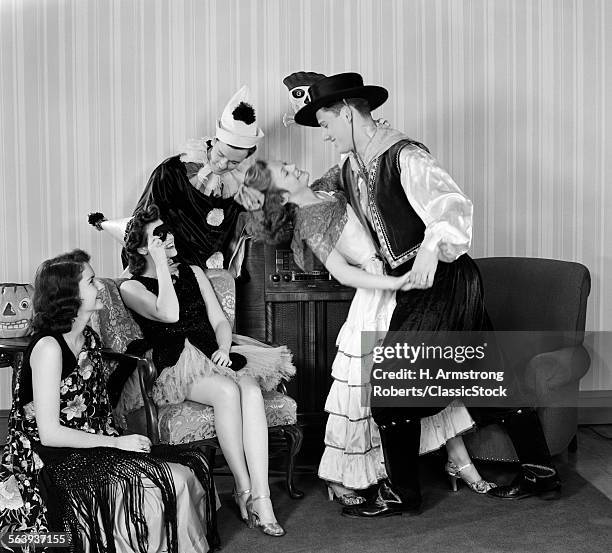 1930s 1940s YOUNG COUPLES DRESSED IN COSTUMES DANCING AT HOME HALLOWEEN PARTY