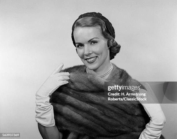 1950s PORTRAIT GLAMOROUS SMILING WOMAN WEARING MINK STOLE WHITE GLOVES PEARLS AND HAT LOOKING AT CAMERA