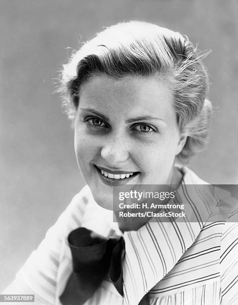 1930s FRECKLE FACED WOMAN SMILING AT CAMERA WEARING STRIPED SHIRT WITH BOW OUTDOORS