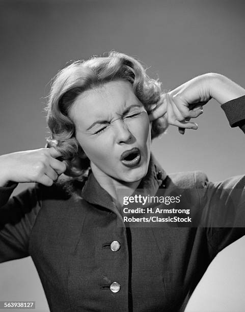 1950s WOMAN PORTRAIT FINGERS PLUGGING EARS