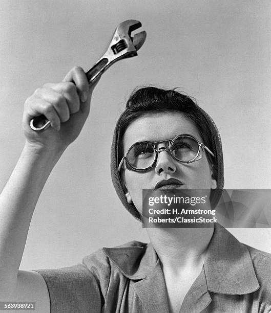 1940s ROSIE THE RIVETER WEARING SAFETY GLASSES HOLDING UP MONKEY WRENCH