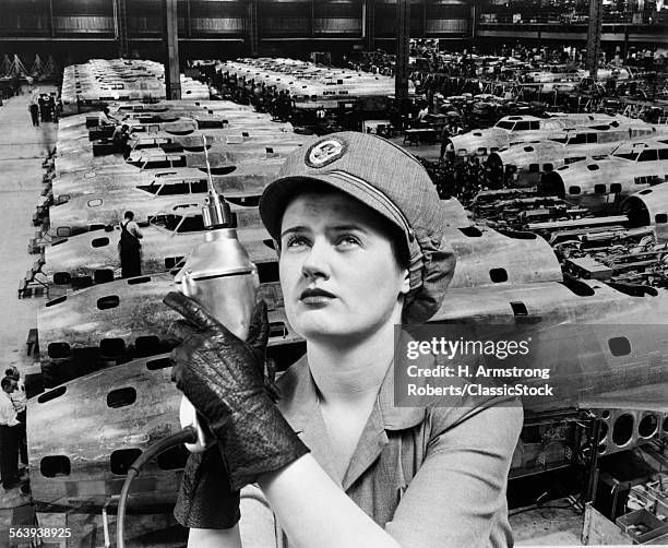 1940s WOMAN ROSIE THE RIVETER SUPERIMPOSED OVER AIRPLANES IN FACTORY 1940s WARTIME WWII