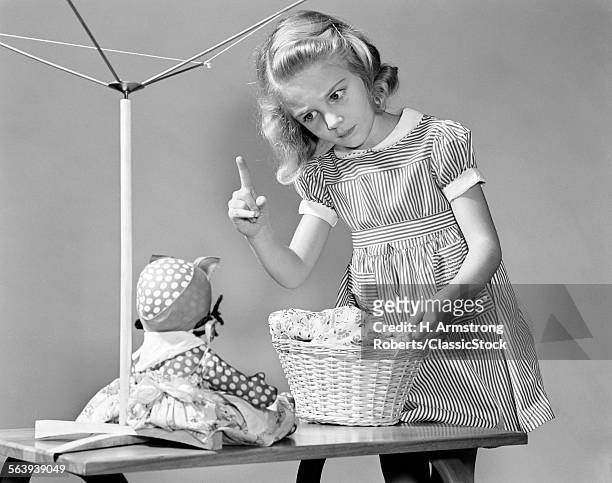 1940s GIRL SHAKING HER FINGER AT DOLL OVER TOY LAUNDRY BASKET