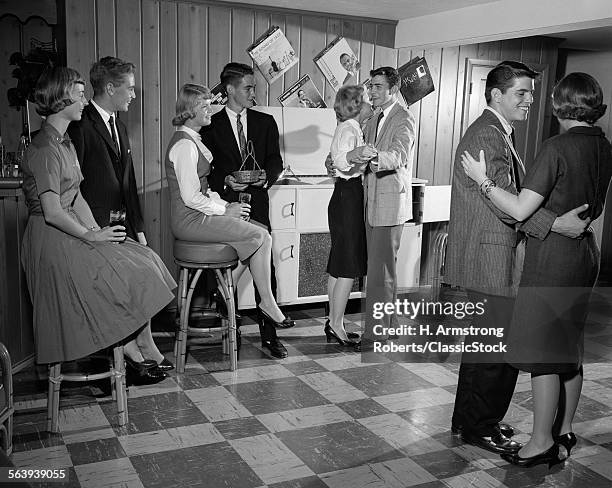 1950s 1960s TEEN COUPLES HAVING PARTY DANCING IN RECREATION ROOM