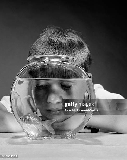 1970s BOY WATCHING GOLDFISH SWIM IN BOWL STUDIO