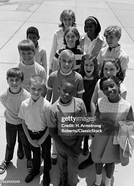1960s 1970s OVERHEAD OF MULTI ETHNIC GROUP OF BOY AND GIRL STUDENTS OUTDOOR