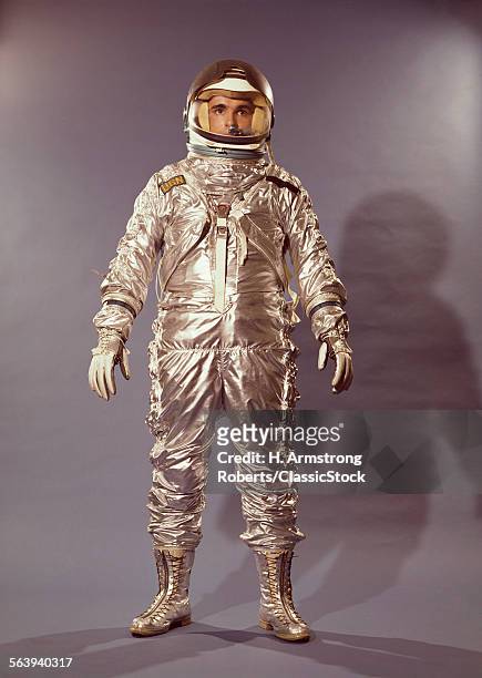 1960s STANDING FULL LENGTH PORTRAIT ASTRONAUT IN SILVER SPACE SUIT AND HELMET