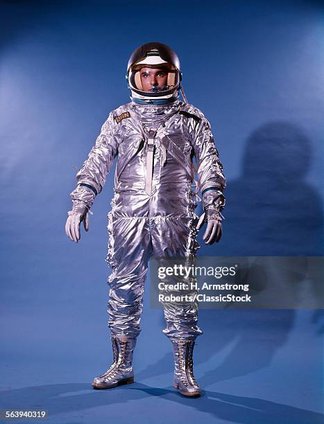 1960s MAN IN SILVER ASTRONAUT SPACE SUIT AND HELMET