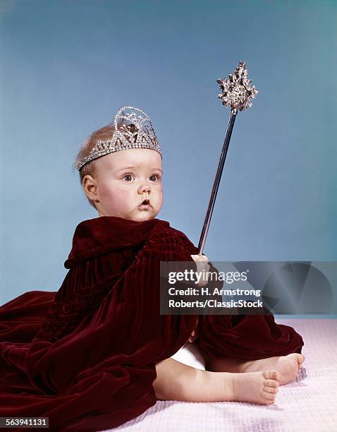 1960s BABY GIRL WEARING RHINESTONE TIARA AND RED VELVET CLOAK HOLDING SCEPTER