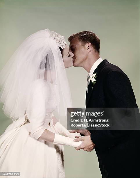1960s BRIDE AND GROOM KISSING