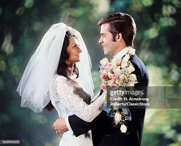 1970s BRIDE GROOM HUGGING FACE TO FACE