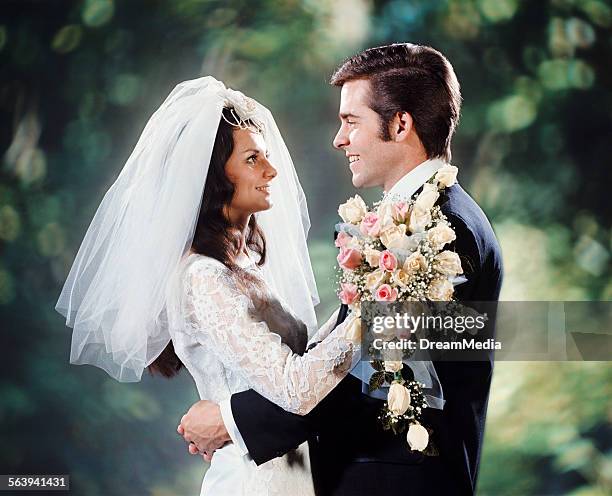 1970s BRIDE GROOM HUGGING FACE TO FACE