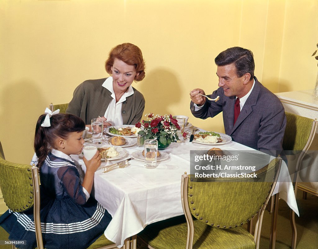 1960s FAMILY ENJOYING...